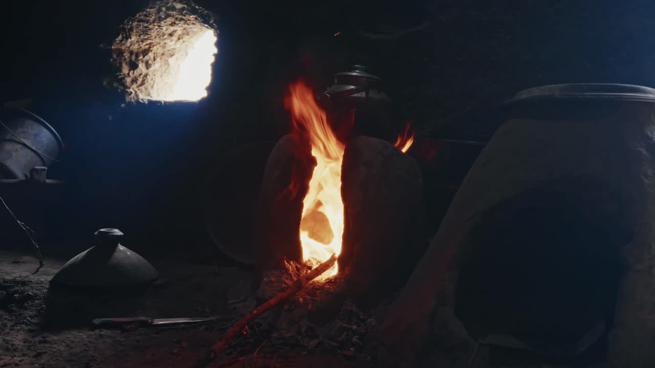 Cooking over an open fire in a rustic home