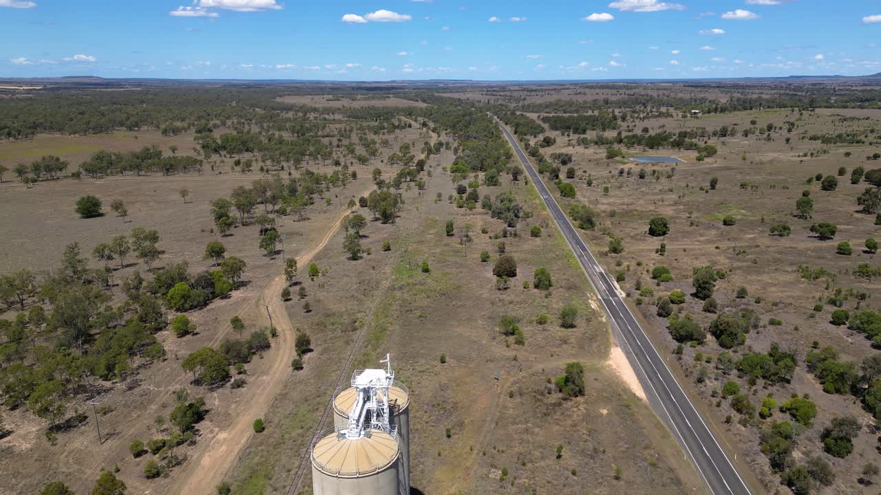 Aerial View of Australian Outback Farmland with Grain Silos and Highway