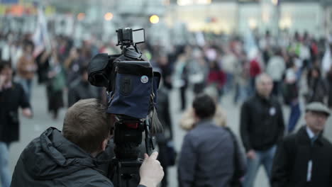 cameraman shoots people at a crowded place