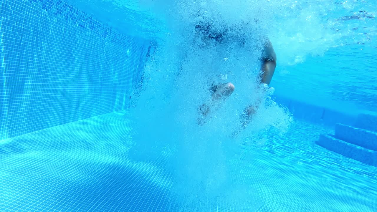Boy jumping in pool. Boy jumping in cool water of swimming pool