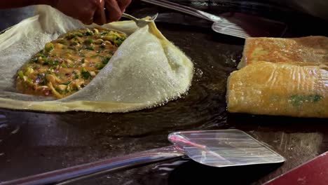 making roti canai: malaysian street food