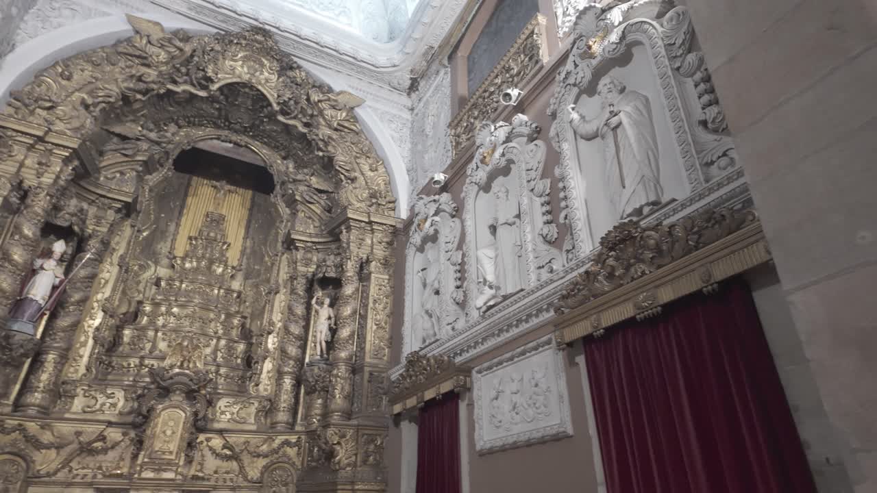 Ornate church interior with detailed architecture and stained glass windows in Porto, Portugal