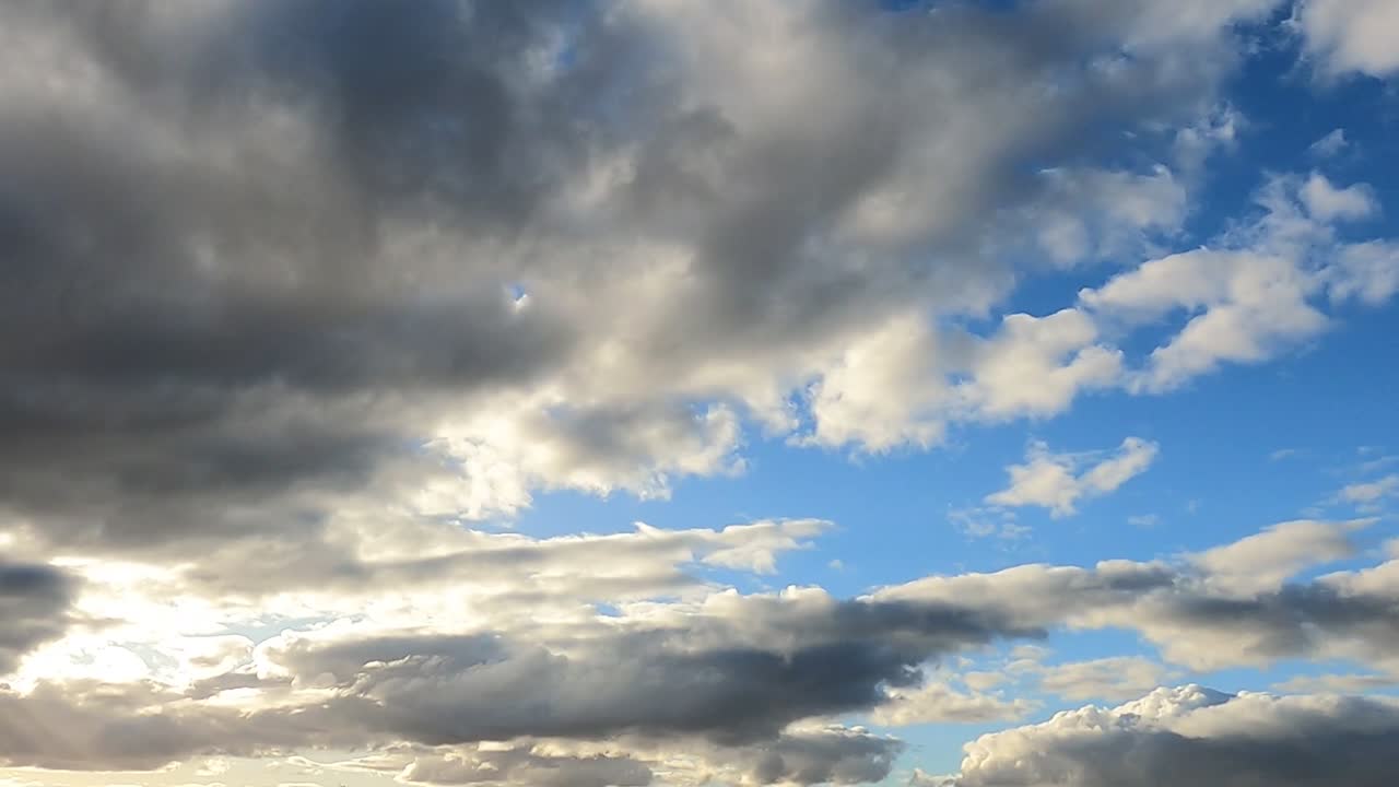 A time-lapse capturing fluffy clouds moving across a bright blue sky, highlighting dynamic weather patterns.