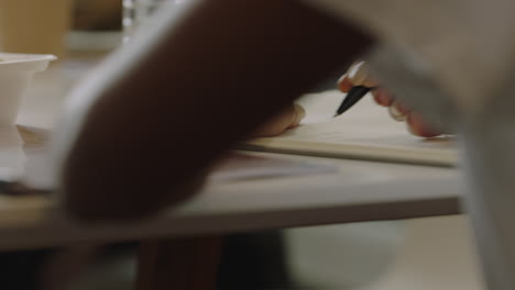 young woman hands writing in journal female student studying taking notes close up