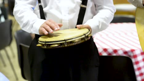 Tambourine-player-at-concert,-flat-plane,-video,-front-view