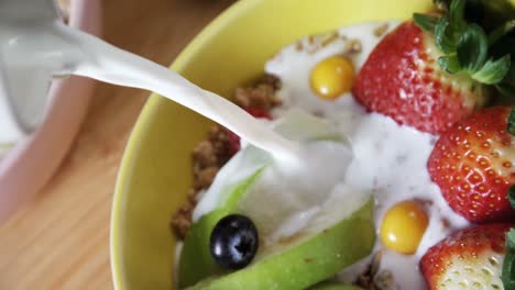 milk being poured on a healthy breakfast 4k