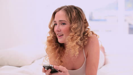dreamy blonde model using her mobile phone