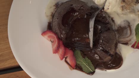 close up of spoon in chocolate volcano lava dessert