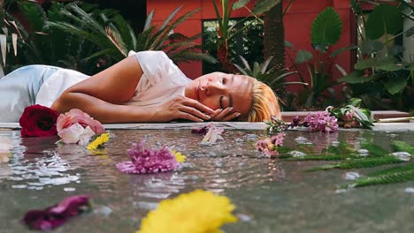 woman resting in a garden among flowers