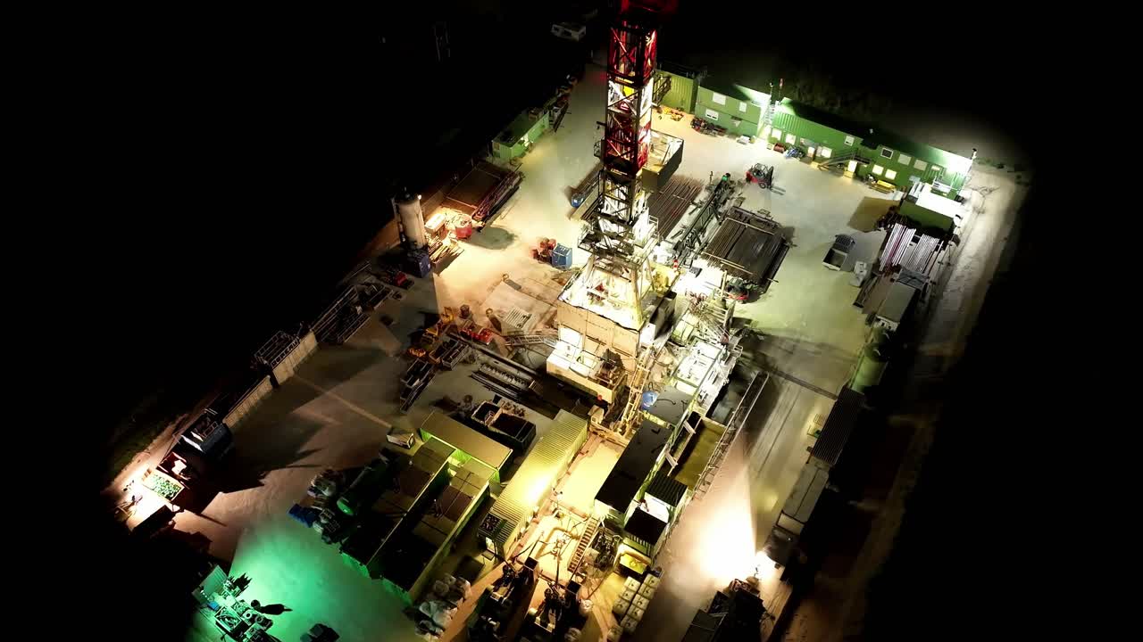 Bird's Eye View Of Gas Drilling Station At Night - aerial drone shot