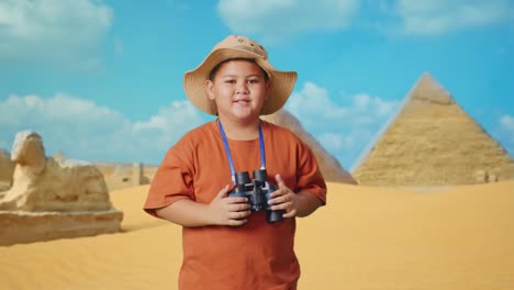 smiling boy explorer in front of egyptian pyramids