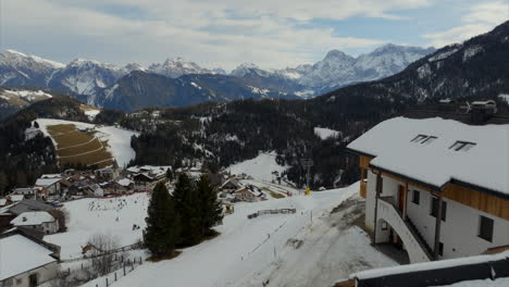 Amazing-aerial-view-of-scenic-ski-resort-in-between-the-mountain-range-of-Sass-de-Putia,-Italian-Dolomites