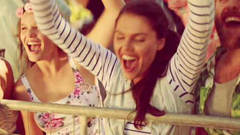 animation of red kaleidoscopic shapes over people having fun at summer music festival