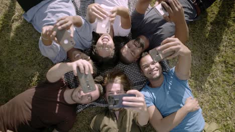 top view of glad young people using smartphones.