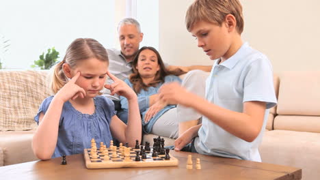 Serious-siblings-playing-chess