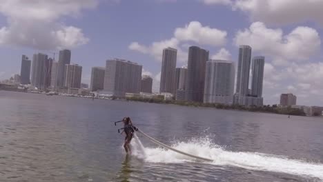 a man hovers using a water jetpack flyboard on the ocean in miami florida