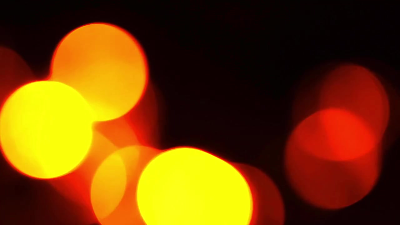 Abstrakt baggrund af glødende røde og gule bokeh-lys