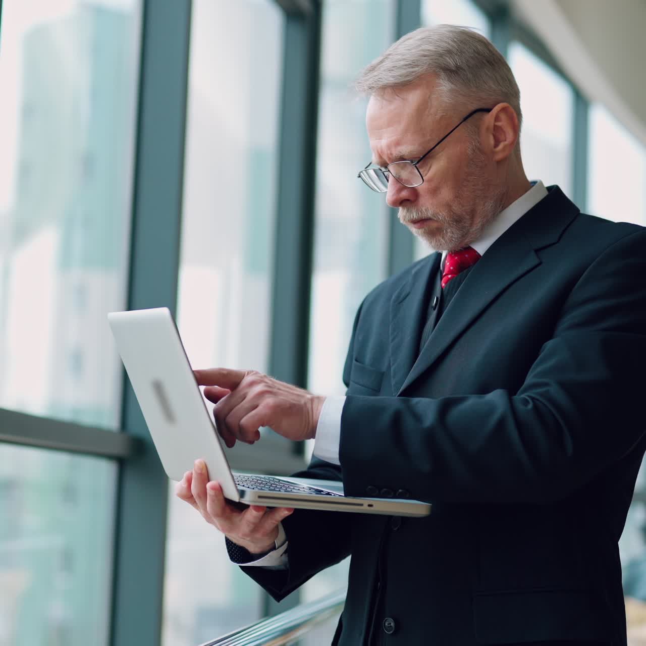 . Senior businessman in cafe. Portrait of businessman using laptop in cafe