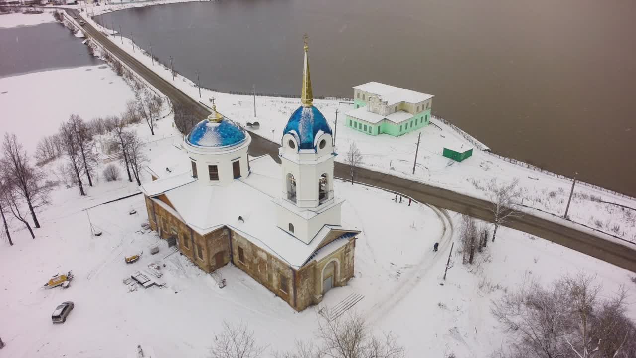 Snødekt ortodoks kirke i en russisk landsby