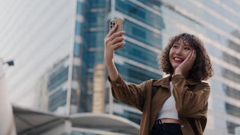 young woman taking a selfie in the city