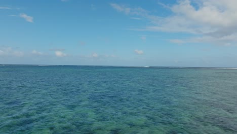 drone flying from the beach towards the famous wave one eye in mauritius