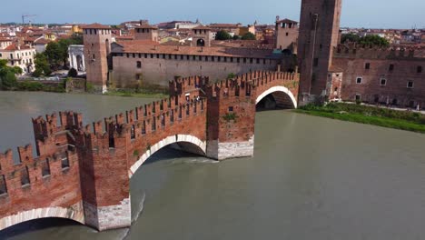 drone view of stunning medieval scaliger bridge (ponte scaligero) leading to castelvecchio in verona on adige river - italy