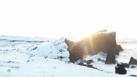 drone shot of beautiful sunset in iceland in winter that shows the sea and the land at the same time