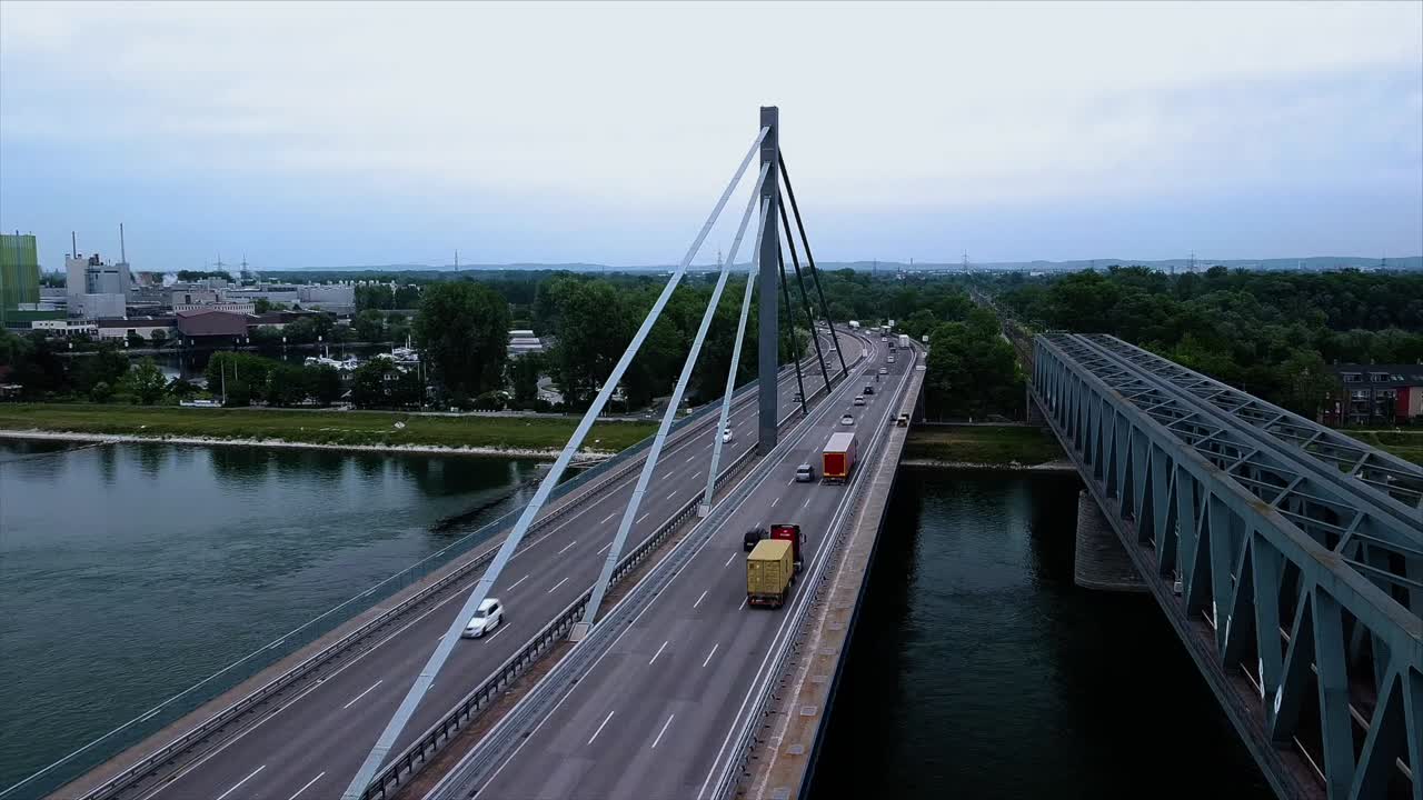 드론이 같은 위치에 있고 카메라 위치가 고정되어 있는 동안 많은 자동차와 트럭이 속도를 내며 많이 사용되는 강 다리의 시간 경과