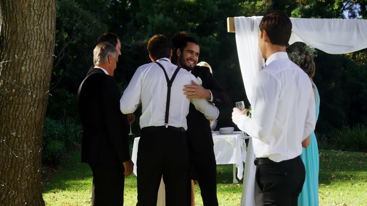 Happy groom hugging guests 4K 4k
