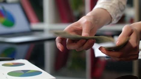 Female-hands-counting-dollar-banknotes-in-office.-Close-up-of-cash-money