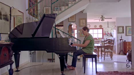 old woman playing a grand piano at her home