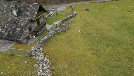 aerial drone top down shot over an old stone walled village house in cavergno village, vallemaggia district, canton of ticino, switzerland at daytime