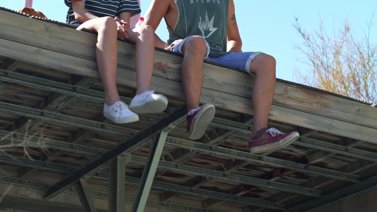 Couple sitting on a wooden deck outside