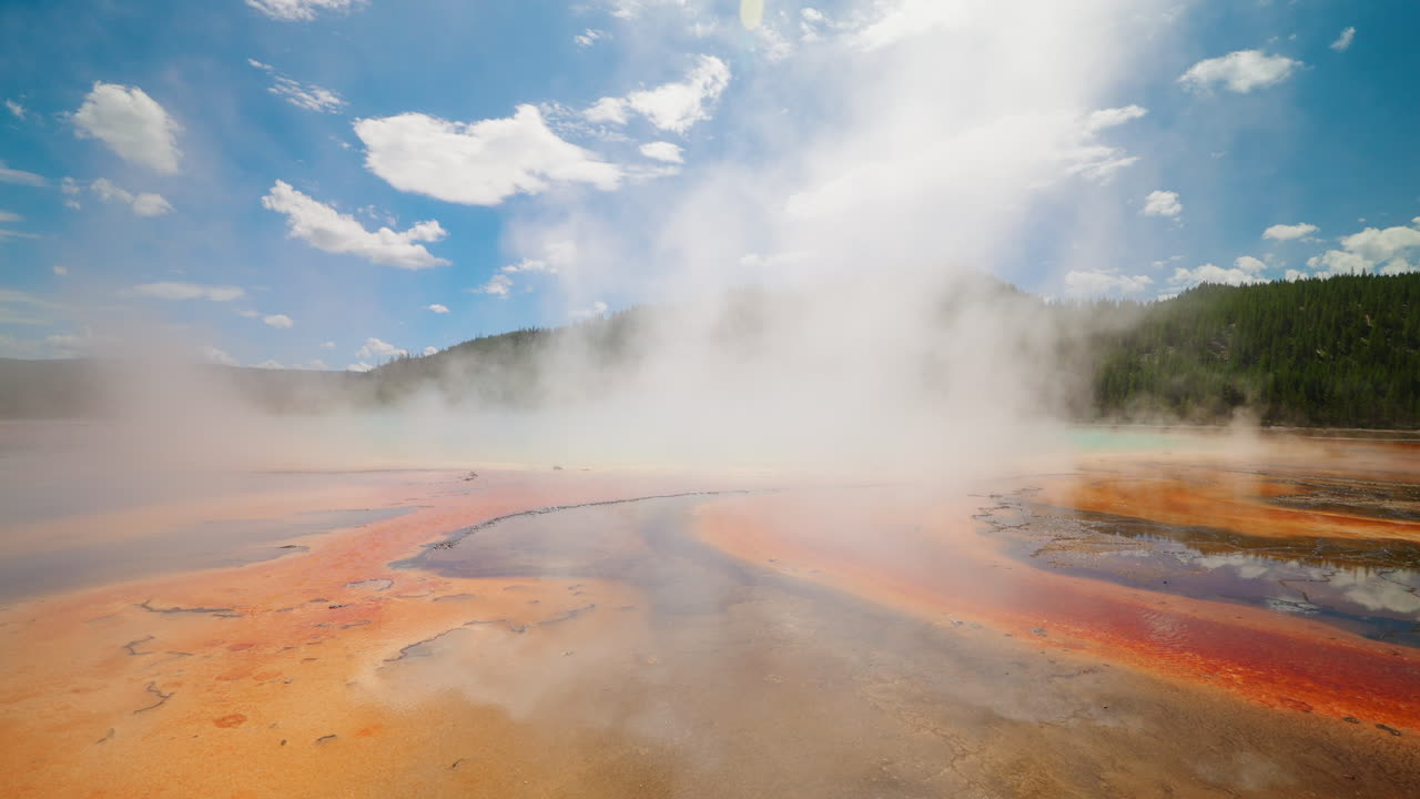 Grand Prismatic Spring in Yellowstone National Park with steam rising