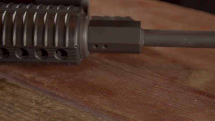 Close dolly over AR-15 barrel on a wooden surface