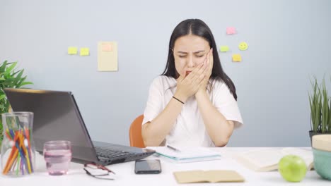 female student suffering from toothache.