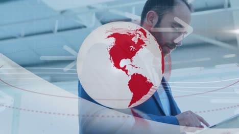 Animation-of-red-and-white-globe-and-arrows-over-businesswoman-using-tablet