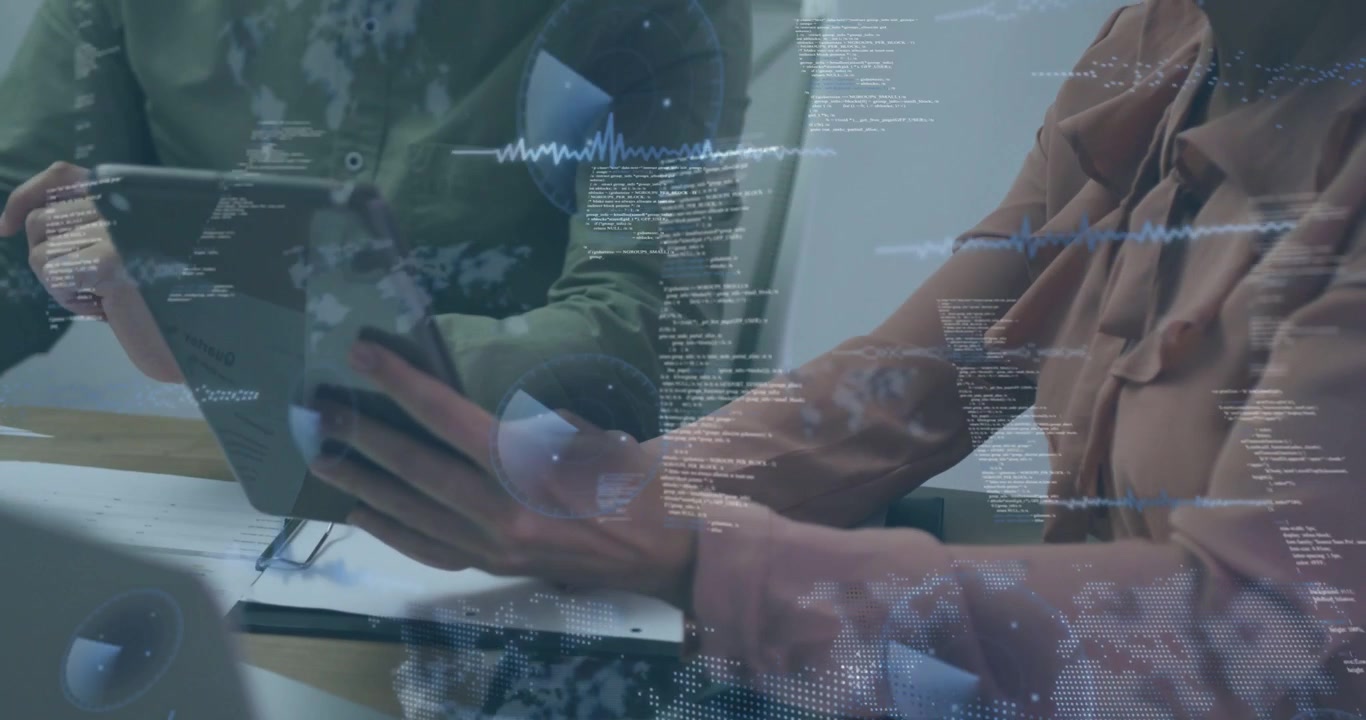 Female colleague lifting tablet at table, rotating for colleague while examining tech data overlays