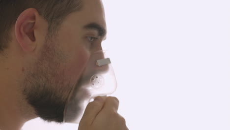 Close-Up-Of-A-Sick-Man-Breathing-Through-Oxygen-Mask