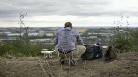 Drone-Pilot-looking-at-a-view-while-preparing-his-drone-for-take-off