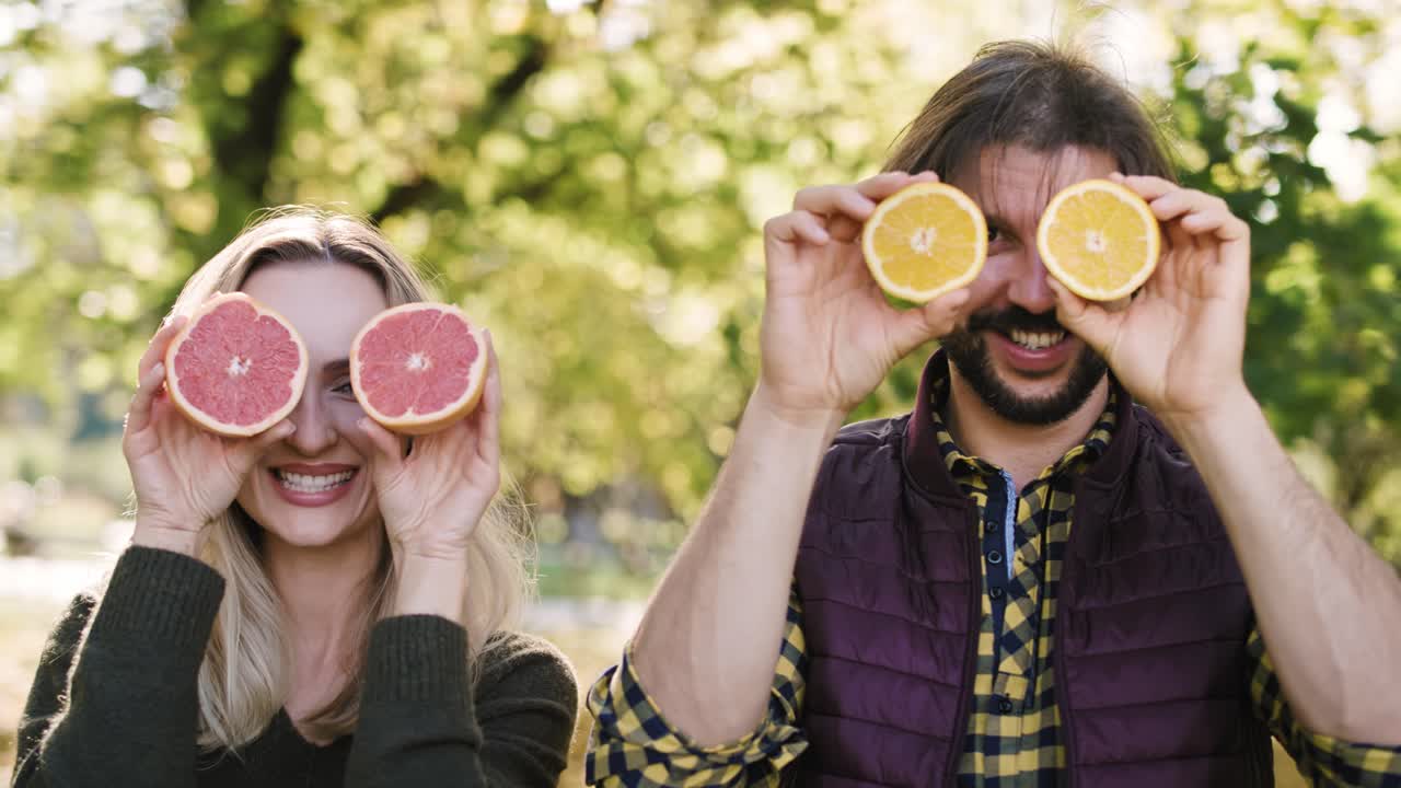 Vista ripresa a mano di coppia giocosa che si diverte con la frutta