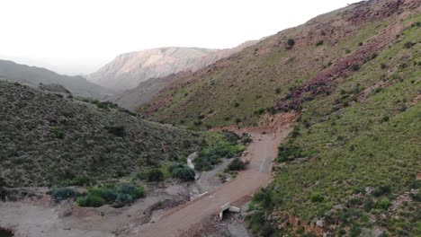 Aerial-Flying-Over-Remote-Road-Through-Mountainous-Valleys-In-Khuzdar