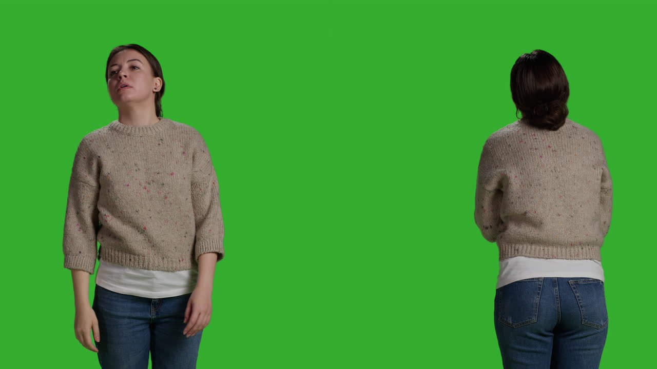 Woman in sweater and jeans on green screen