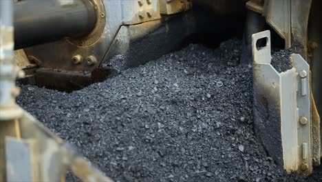 compressing, compacting, leveling and smoothing the asphalt road surface using a asphalt paver finisher