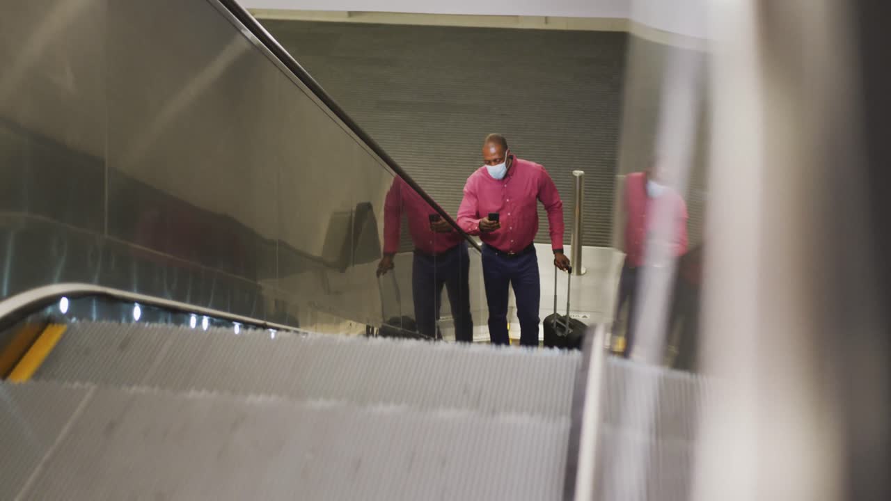 African american man on the go wearing coronavirus covid19 mask