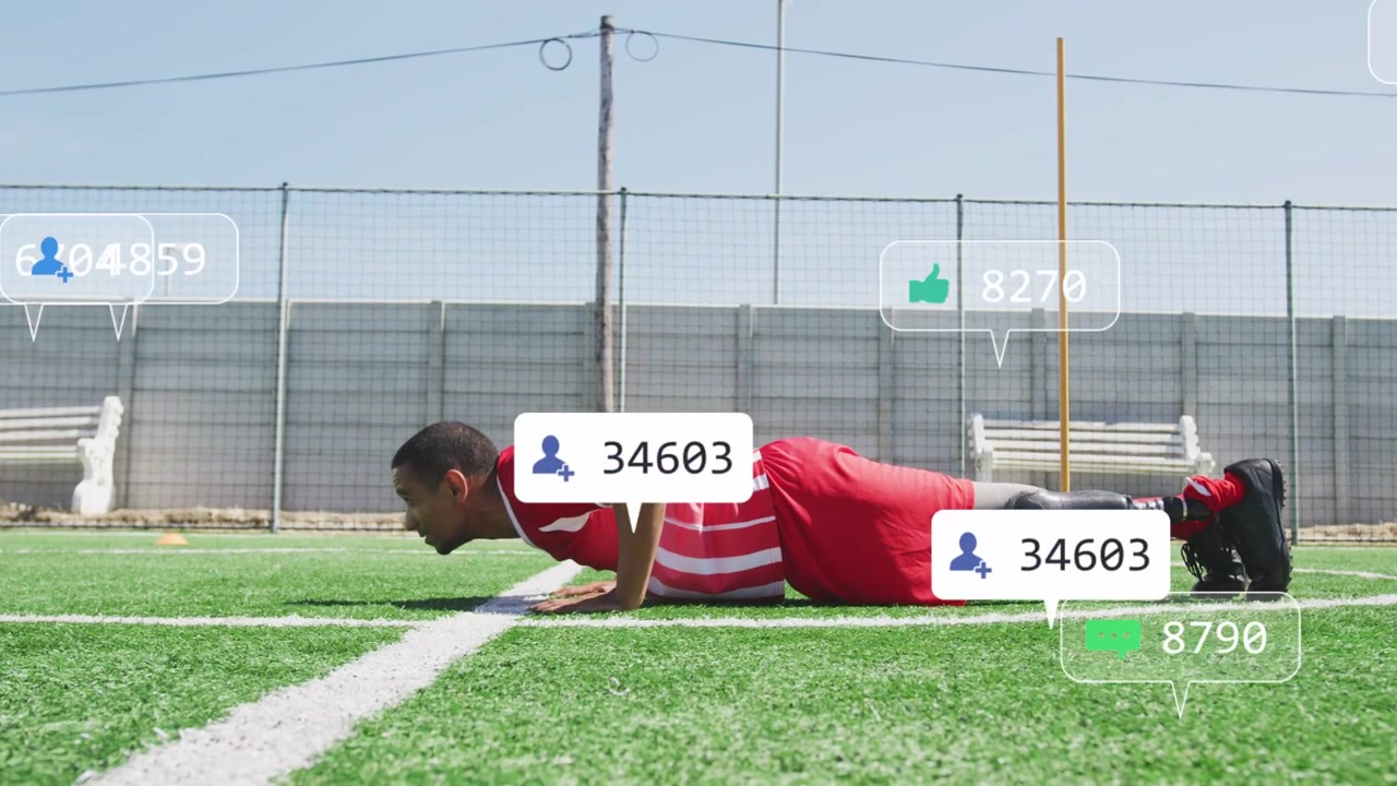 Man starting high plank and doing pushups on turf while training with icons popping over torso