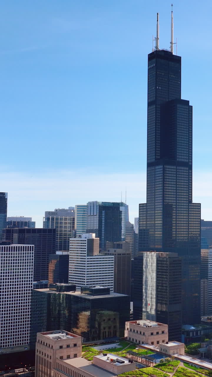 Chicago, Illinois, USA - June 01, 2024: Skyline with view of the Willis Tower, known as Sears Tower on blue background. Aerial view. Vertical video