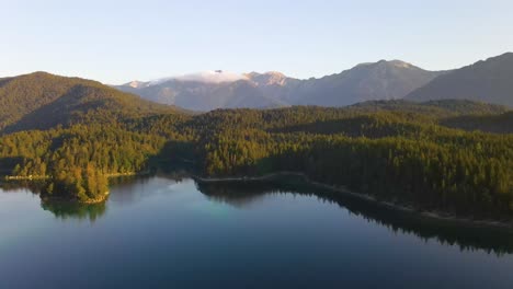 aerial footage of lake eibsee beneath zugspitze peak with small islands