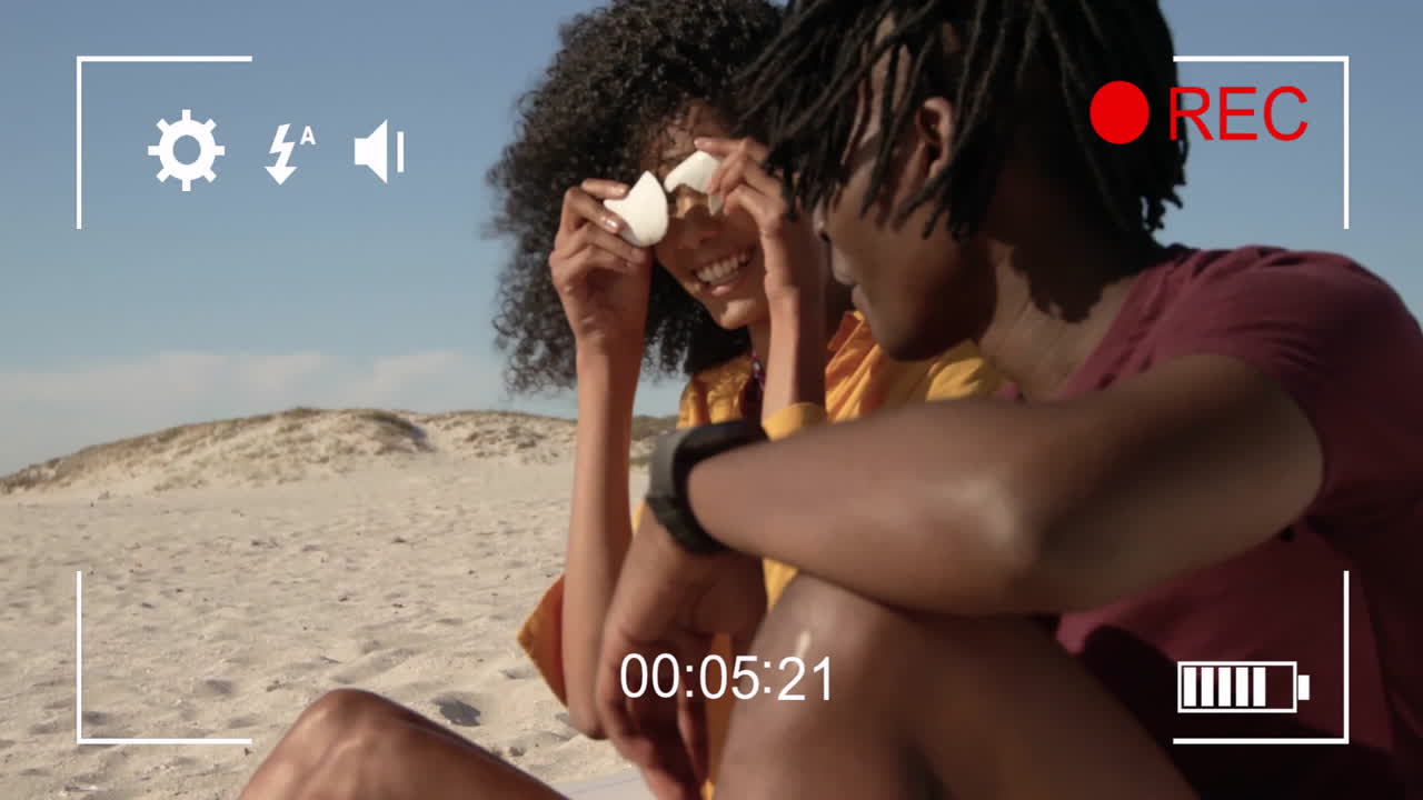 Recording animation over couple enjoying time together on sandy beach