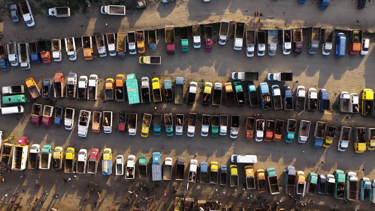 Karakol Animal Market Parking Lot Filled With Vehicles For Transporting Livestock Animals In Kyrgyzstan. - aerial shot